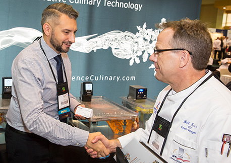 Exhibitor and chef shaking hands